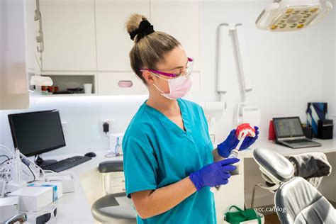 Dental assistant assisting dentist