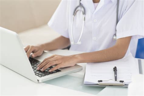 Healthcare IT specialist working on a computer