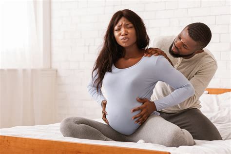 A woman in labor, surrounded by supportive family and medical staff