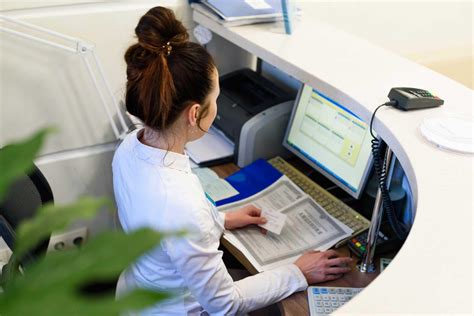 Medical office receptionist working on a computer