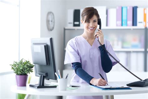 Medical office receptionist working at a desk