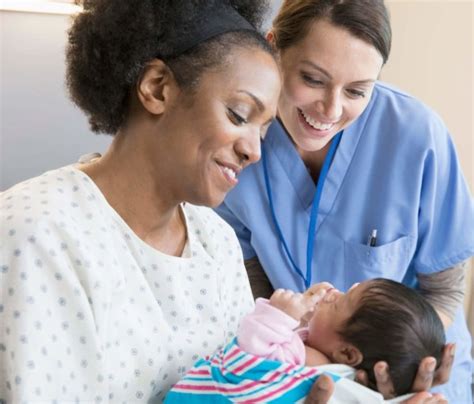 Midwife nurse assisting a new mother