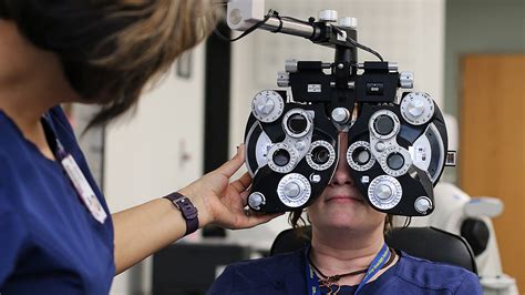 ophthalmic technician assisting a patient