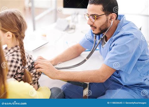 Pediatrician examining child