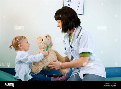 Pediatrician playing with child