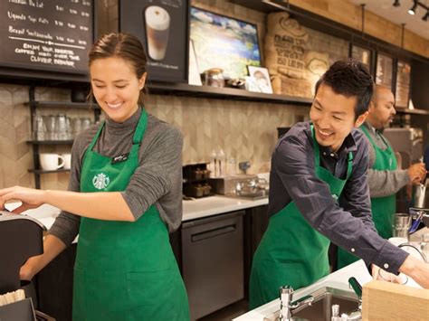 Starbucks barista making a latte