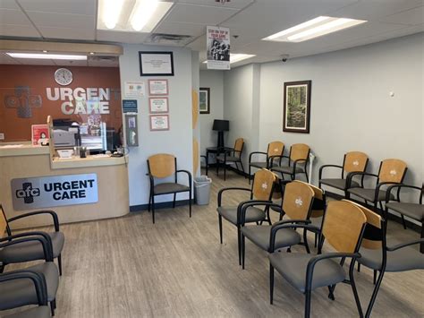 Urgent care center staff member explaining pricing to a patient